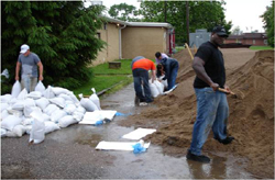 field school participants Joshua Brown, Chris Valvano, and others help sand-bagging efforts in 2008